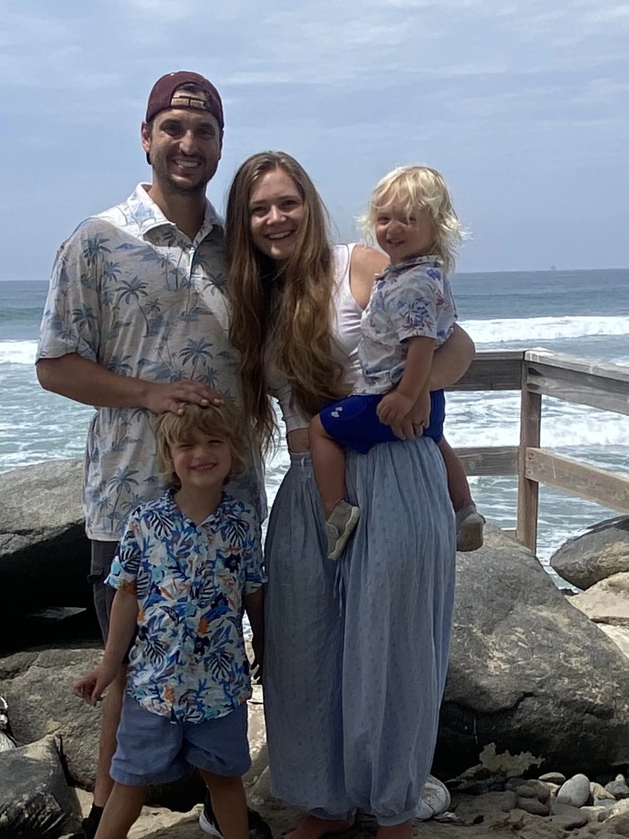 Dr. Taylor Lyle with her husband and two young sons on a beach